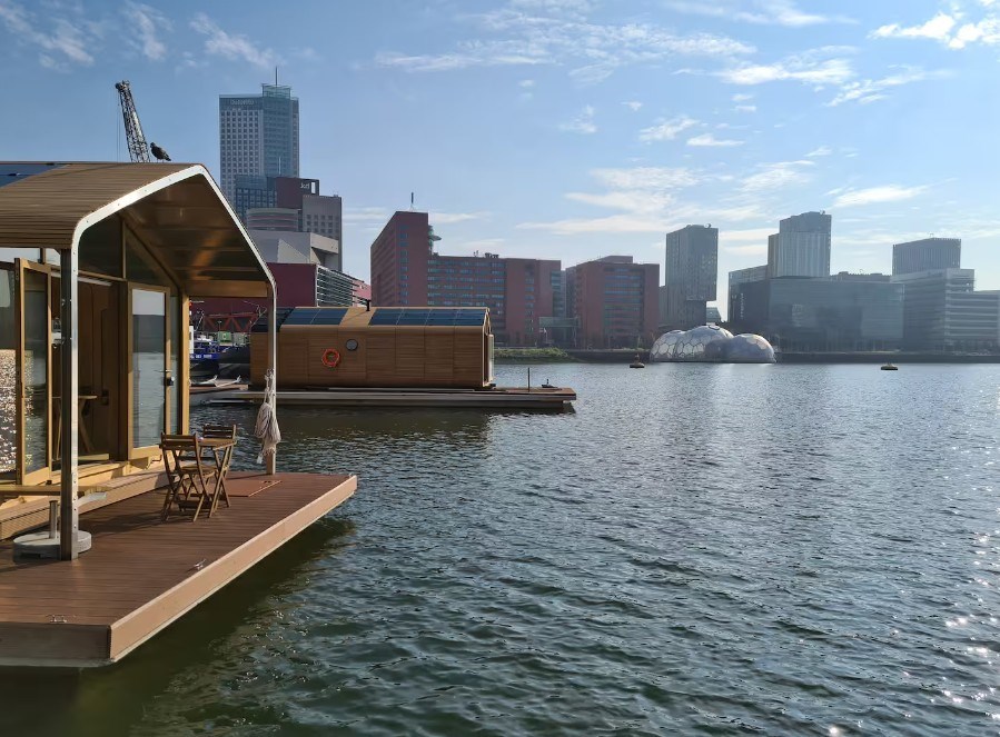 Bubbelen in de privéjacuzzi van je Tiny house op het water met uitzicht op de haven van Rotterdam
